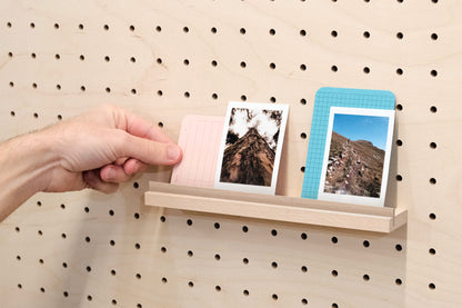 Wooden chair rail for Pegboard and book display