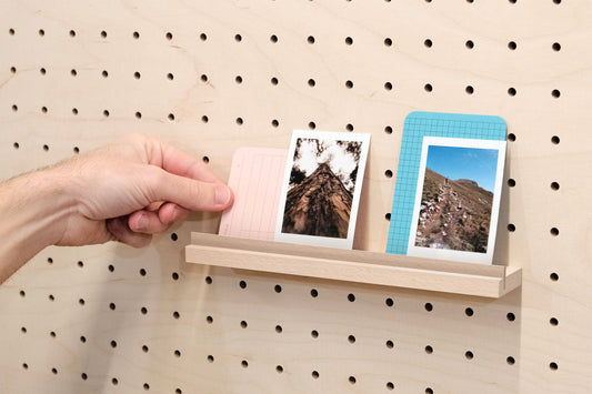 Wooden chair rail for Pegboard and book display