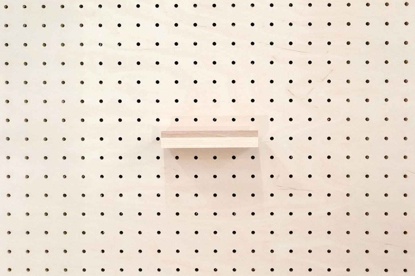 Wooden chair rail for Pegboard and book display