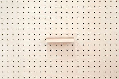 Wooden chair rail for Pegboard and book display