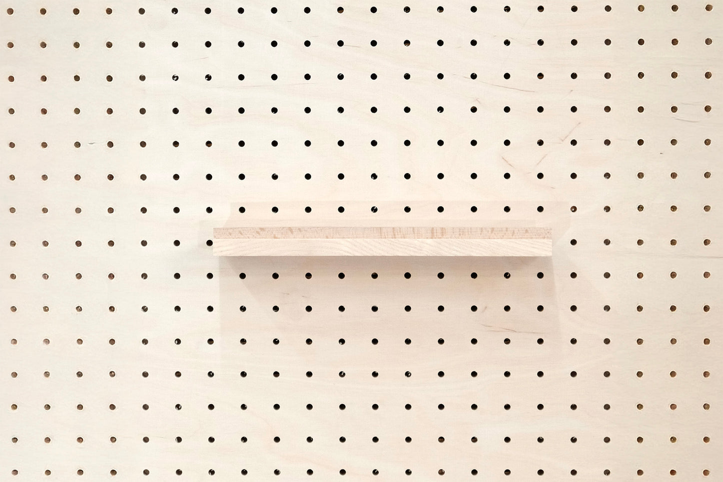 Wooden chair rail for Pegboard and book display